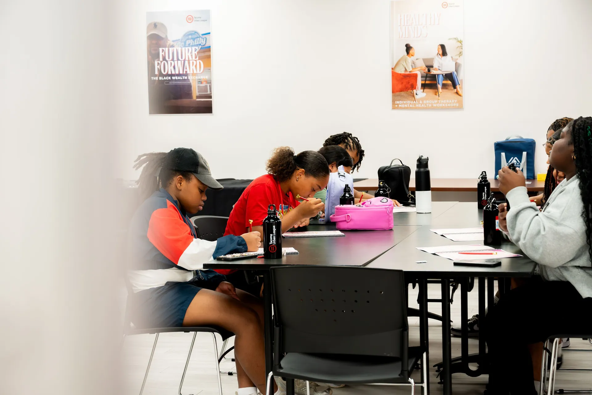 Students work together at a table during a Tacoma Urban League program session